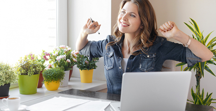Woman stretching at her computer